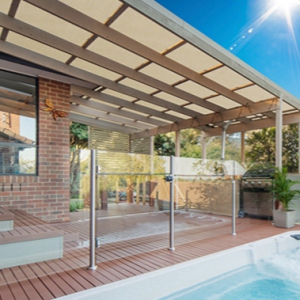 Patio enclosure with netting for sun relief over pool area