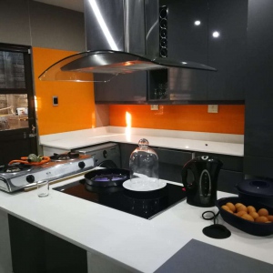 Coloured glass splashback looks fantastic with lighting and chrome